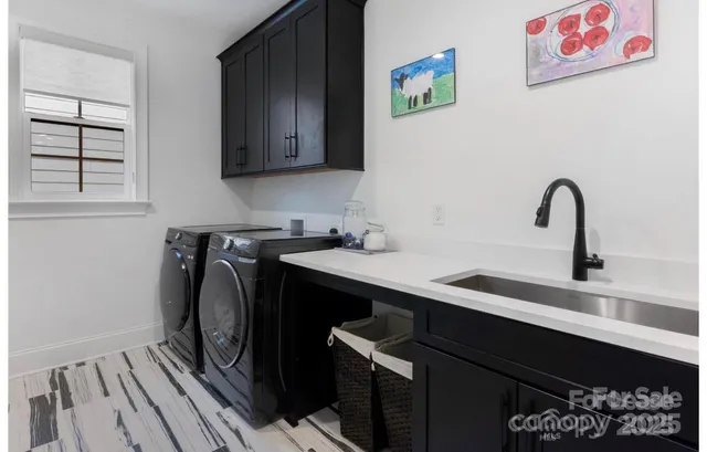 a utility room with sink dryer and washer