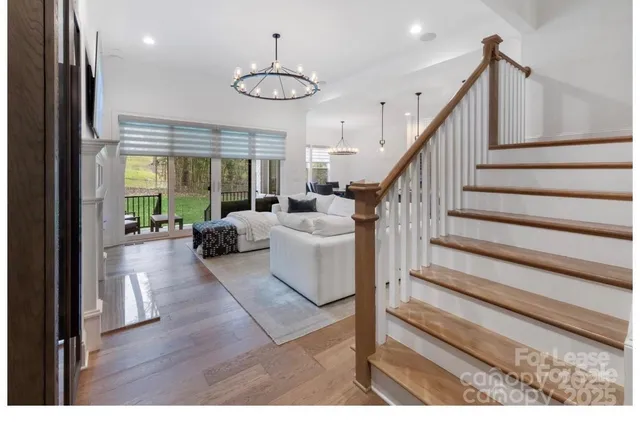 a living room with wooden floor and furniture