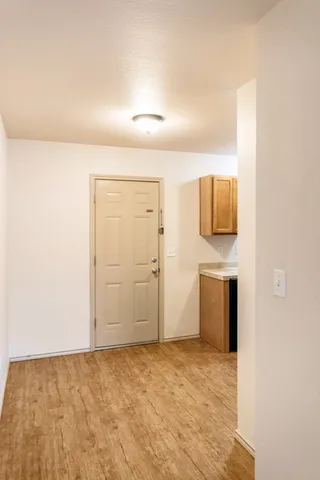 a view of a kitchen with white cabinets