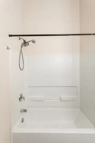 a bathroom with a shower and a bath tub