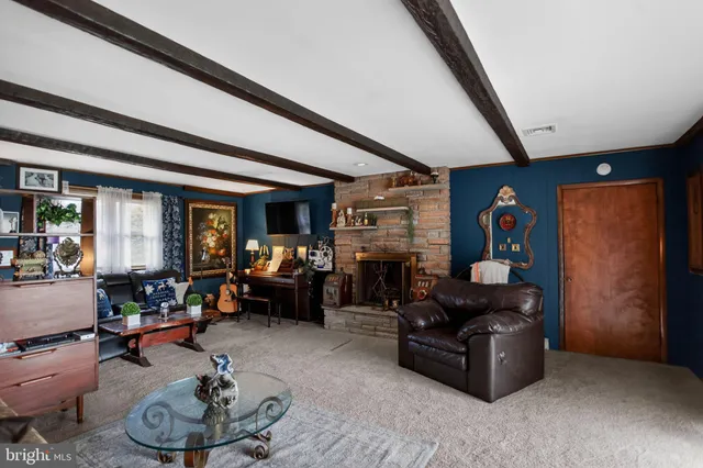 a kitchen with stainless steel appliances kitchen island granite countertop a stove a sink dishwasher a dining table and chairs with wooden floor