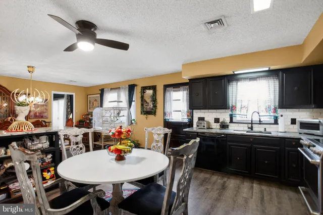 a view of a dining room with furniture and wooden floor