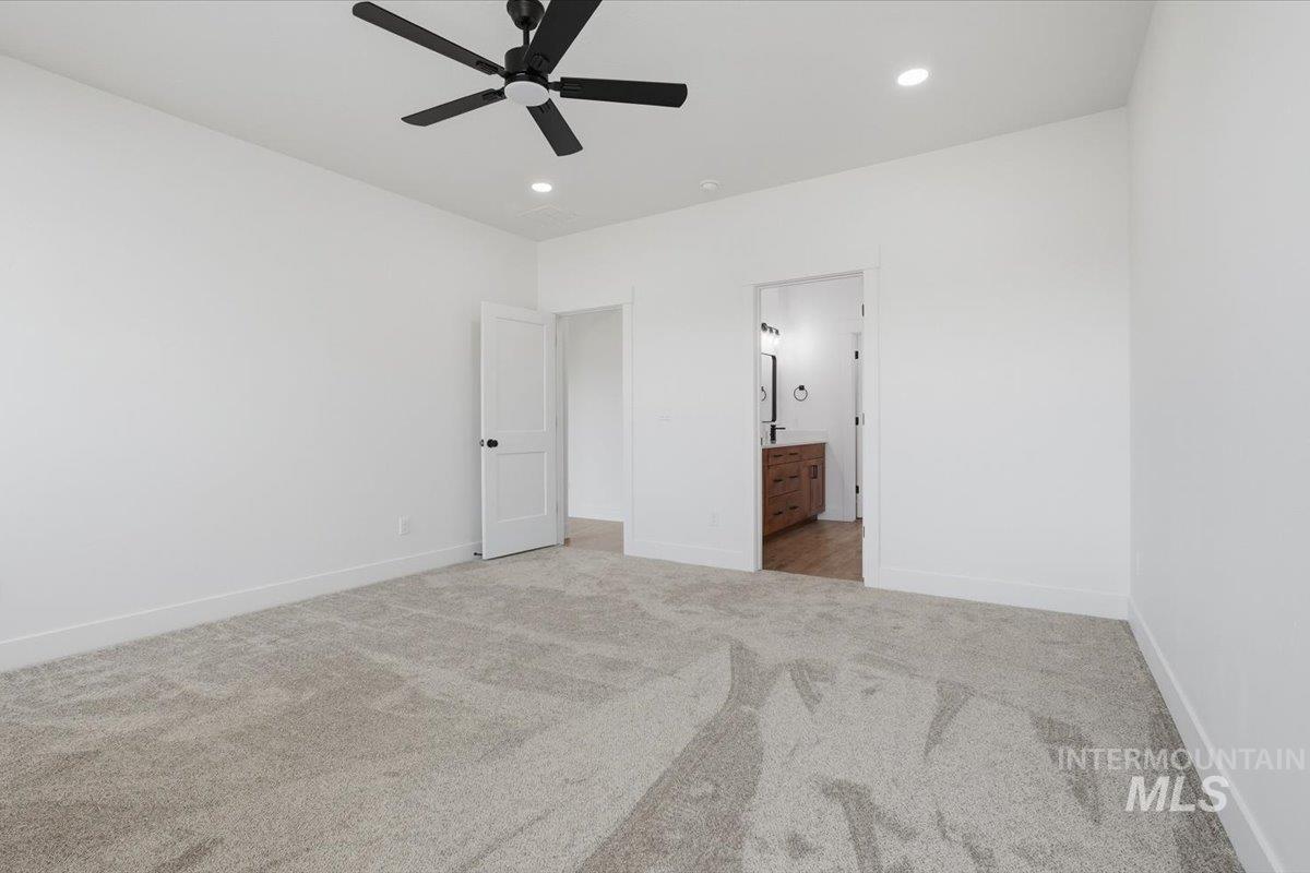 2175 Austin Way Fruitland, ID 83619 - Photo 22 of 30 Unfurnished bedroom featuring light carpet, ensuite bath, ceiling fan, and recessed lighting
