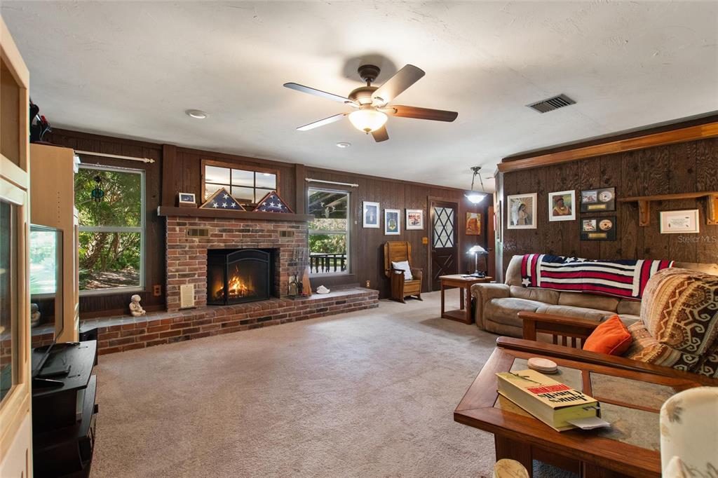 3641 Turtle Mound Road Melbourne, FL 32934 - Photo 21 of 77 a living room with furniture and a fireplace