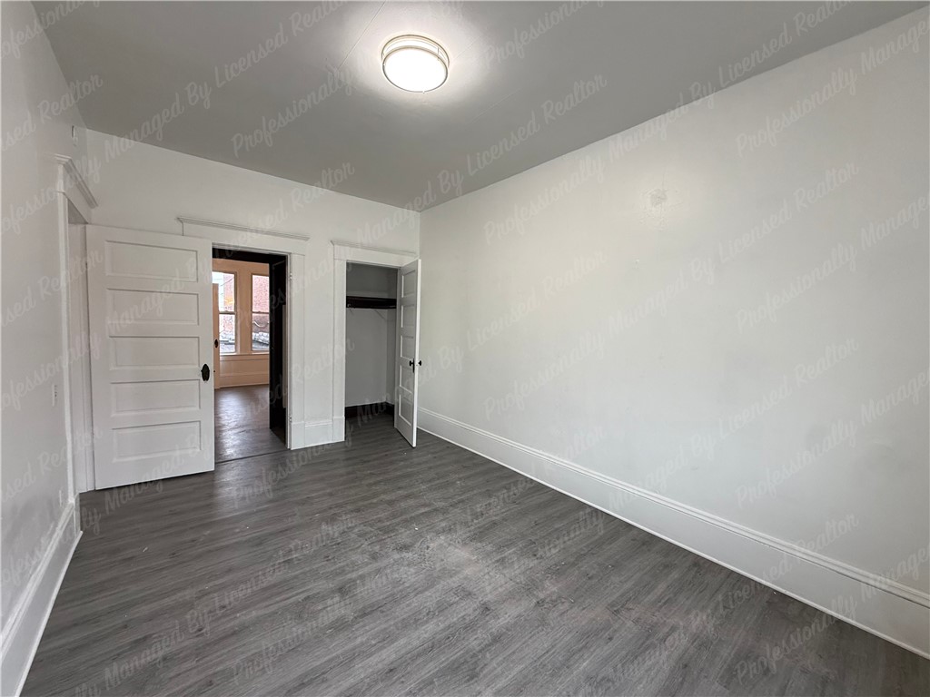 44 West High Street, Unit B Springfield, OH 45502 - Photo 12 of 31 This bright room features a spacious layout and durable flooring, offering a versatile living space.