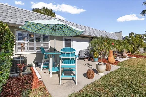 a view of a chairs and table in backyard