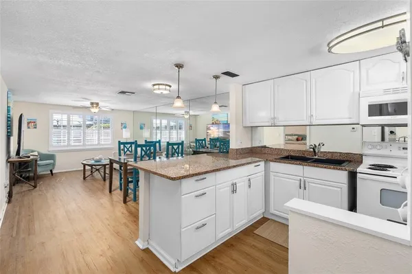 a kitchen with a sink a stove and refrigerator