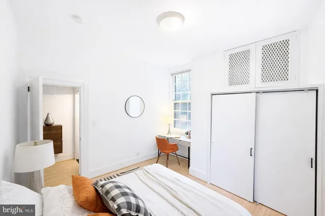 a bedroom with a bed and a window