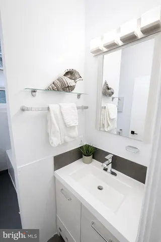 a white toilet sitting next to a bathroom sink