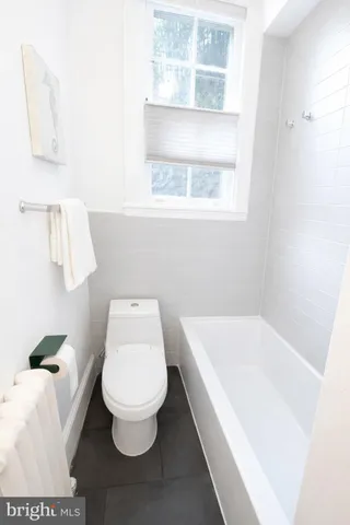 a bathroom with a tub and shower