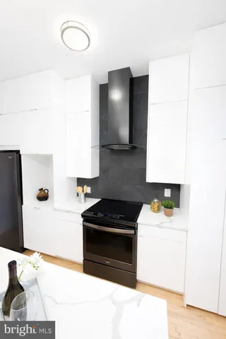 a kitchen with a sink and a stove top oven