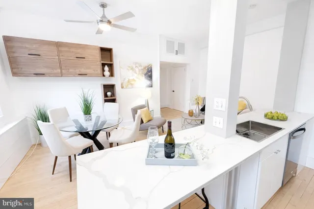 a living room with furniture a dining table and a flat screen tv
