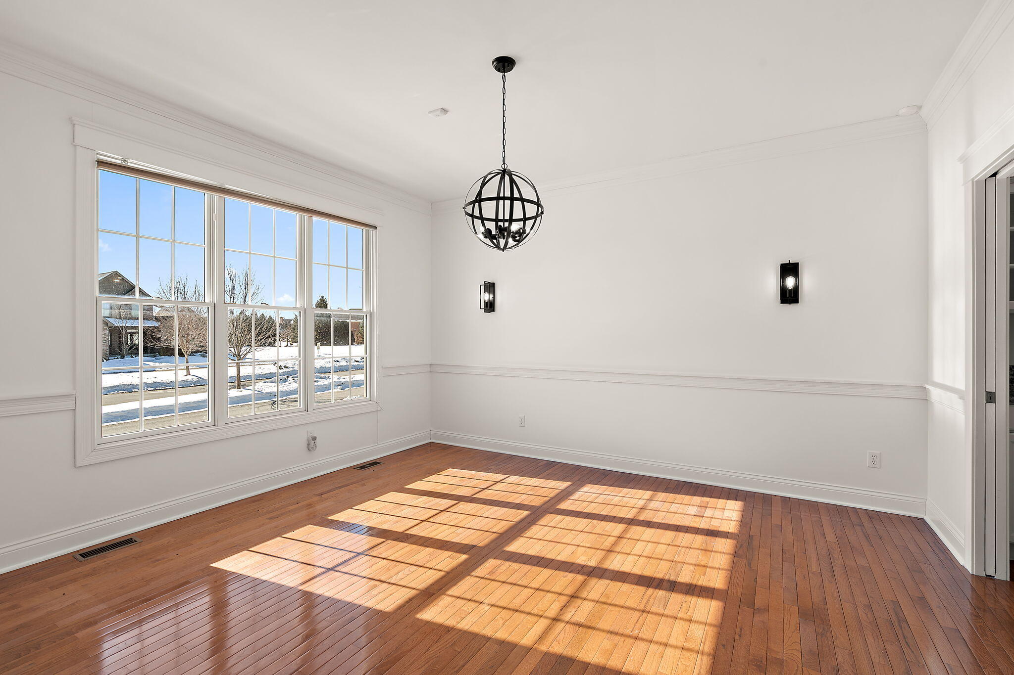 1240 Ryder Road Chesterton, IN 46304 - Photo 12 of 65 a view of an empty room with wooden floor and a window