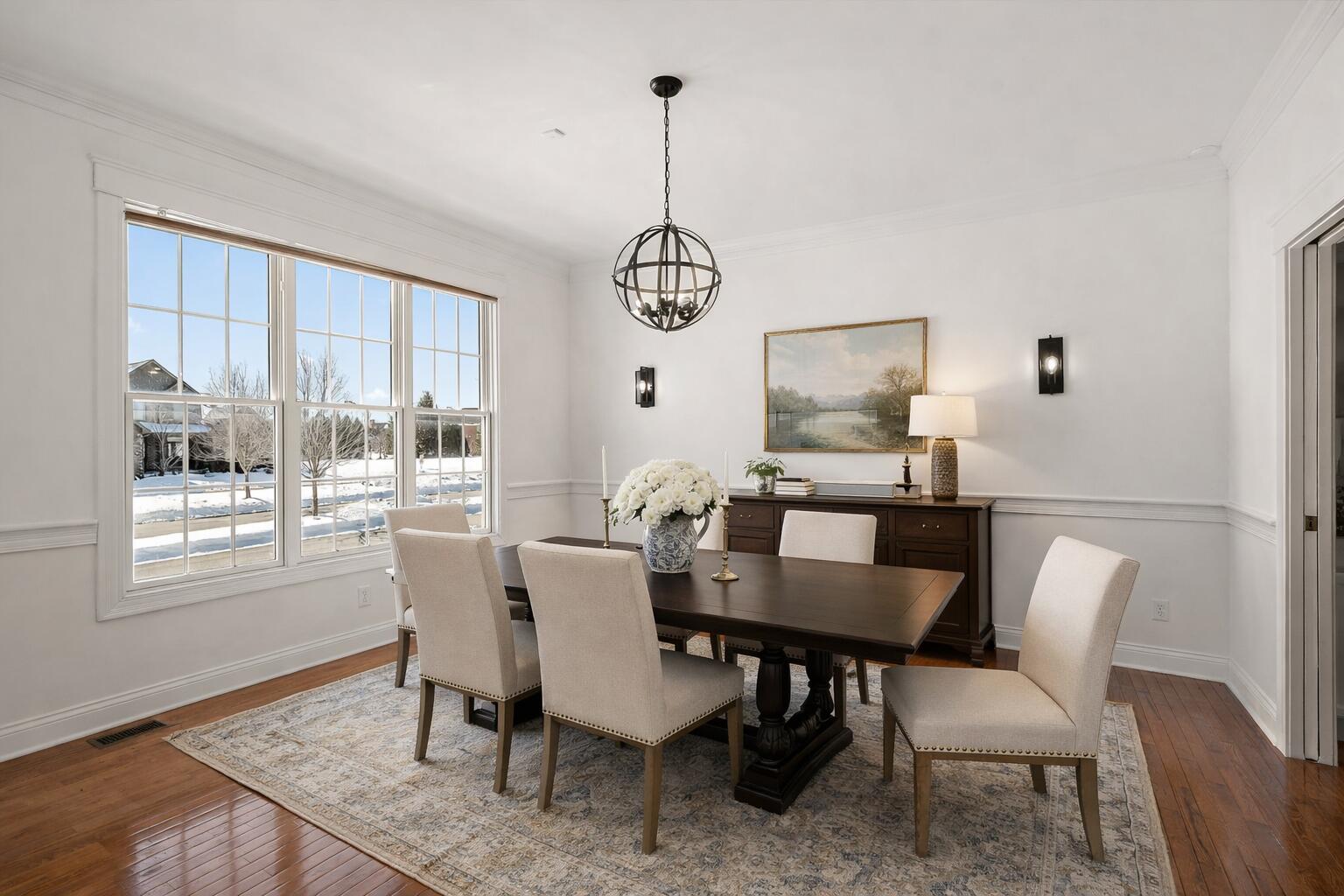1240 Ryder Road Chesterton, IN 46304 - Photo 15 of 73 a dining room with furniture a chandelier and wooden floor