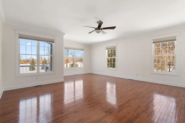 a view of a hallway with wooden floor and entryway
