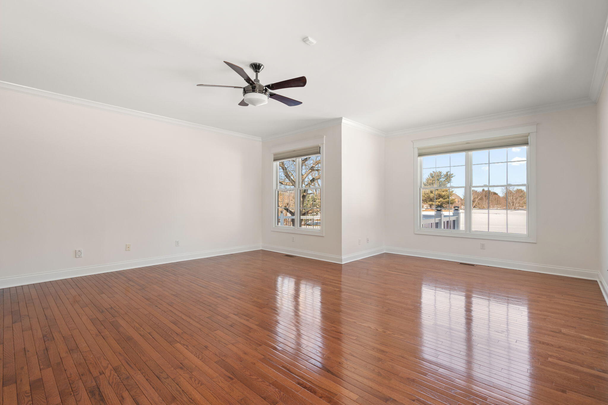 1240 Ryder Road Chesterton, IN 46304 - Photo 27 of 65 an empty room with wooden floor a ceiling fan and windows