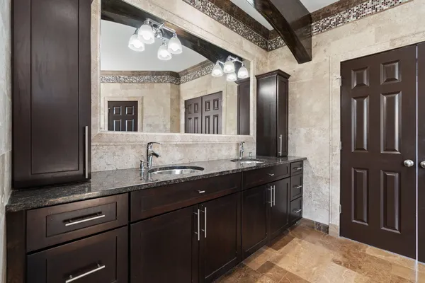 a bathroom with a sink a toilet and a mirror