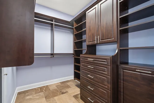 a spacious bedroom with a bed couch and a window