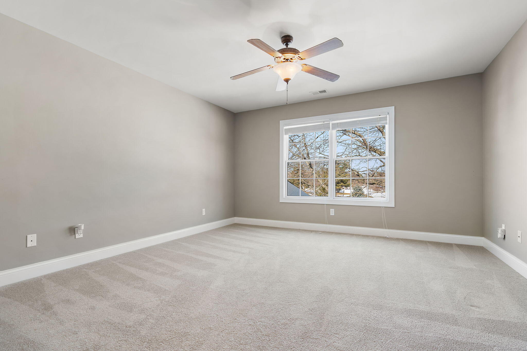 1240 Ryder Road Chesterton, IN 46304 - Photo 41 of 65 an empty room with windows and ceiling fan