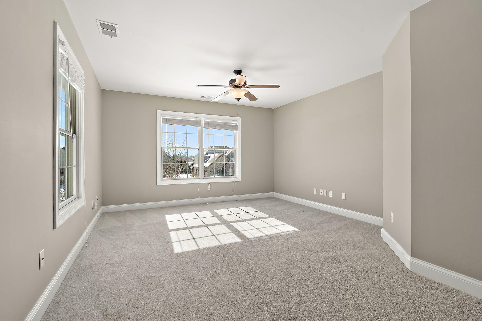 1240 Ryder Road Chesterton, IN 46304 - Photo 44 of 65 an empty room with windows and ceiling fan