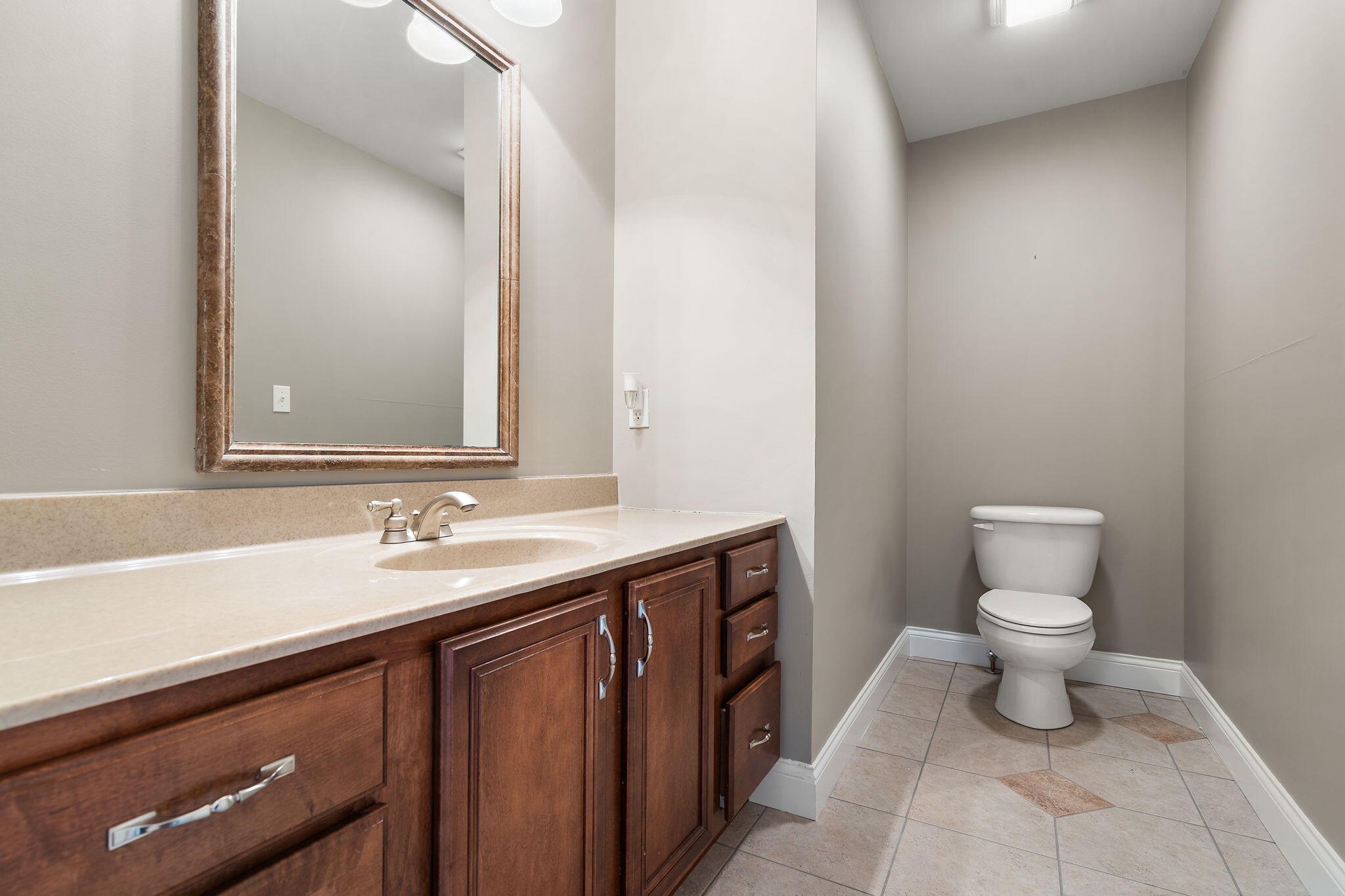 1240 Ryder Road Chesterton, IN 46304 - Photo 47 of 73 a bathroom with a sink a toilet and a mirror
