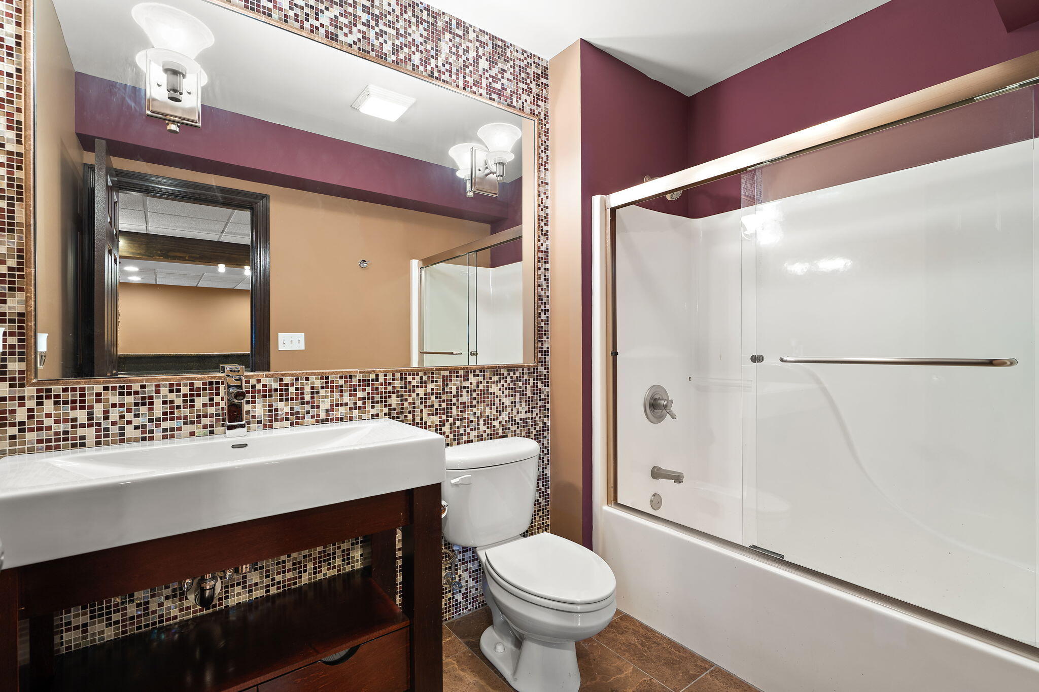 1240 Ryder Road Chesterton, IN 46304 - Photo 48 of 65 a bathroom with a sink a toilet a mirror and shower
