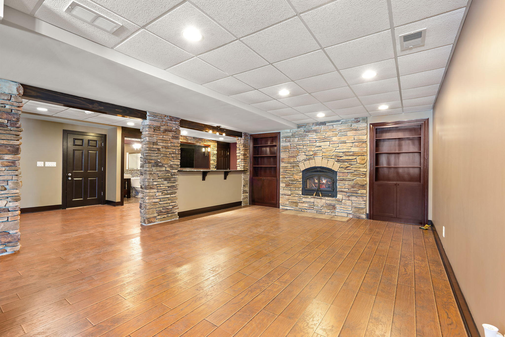 1240 Ryder Road Chesterton, IN 46304 - Photo 56 of 73 a view of empty room with wooden floor and fireplace