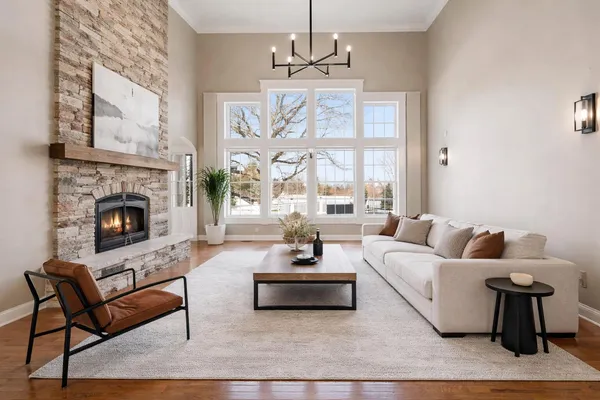 a living room with furniture a rug and a window