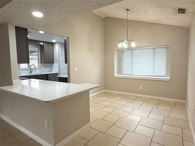 a view of an empty room with a chandelier