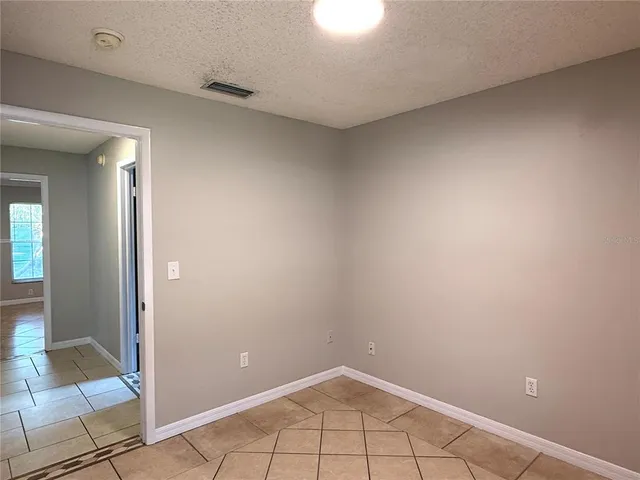 a view of a livingroom with an empty space and a window