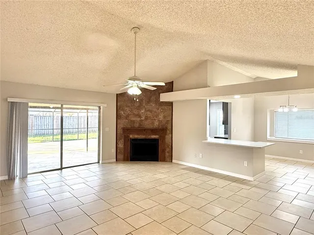 a view of empty room with wooden floor and fireplace