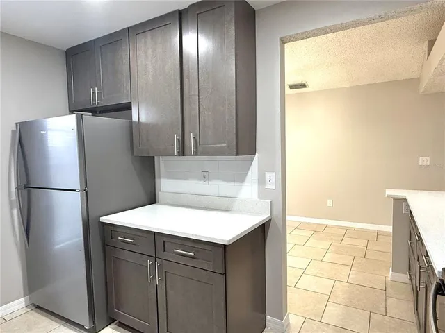 a kitchen with a refrigerator and a sink