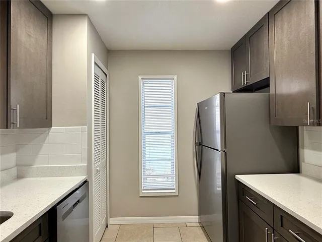 a kitchen with a refrigerator and a sink