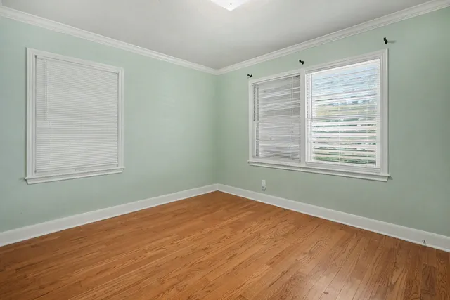 a view of a room with wooden floor and windows