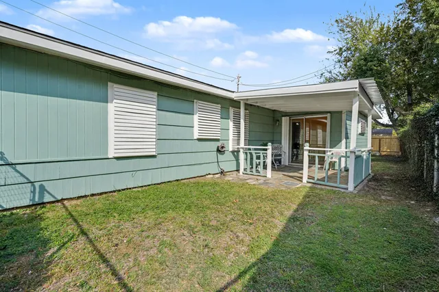 a view of a house with backyard and sitting area