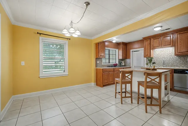 a kitchen with stainless steel appliances granite countertop a sink and a refrigerator