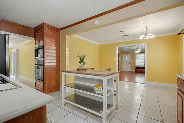 a view of kitchen with sink and refrigerator
