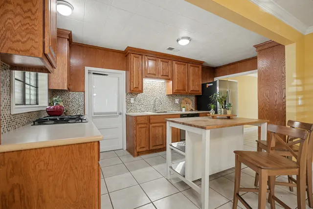 a kitchen with a sink appliances and cabinets