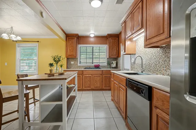 a kitchen with stainless steel appliances granite countertop sink stove top oven and cabinets