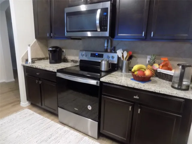 a kitchen with granite countertop a sink and cabinets