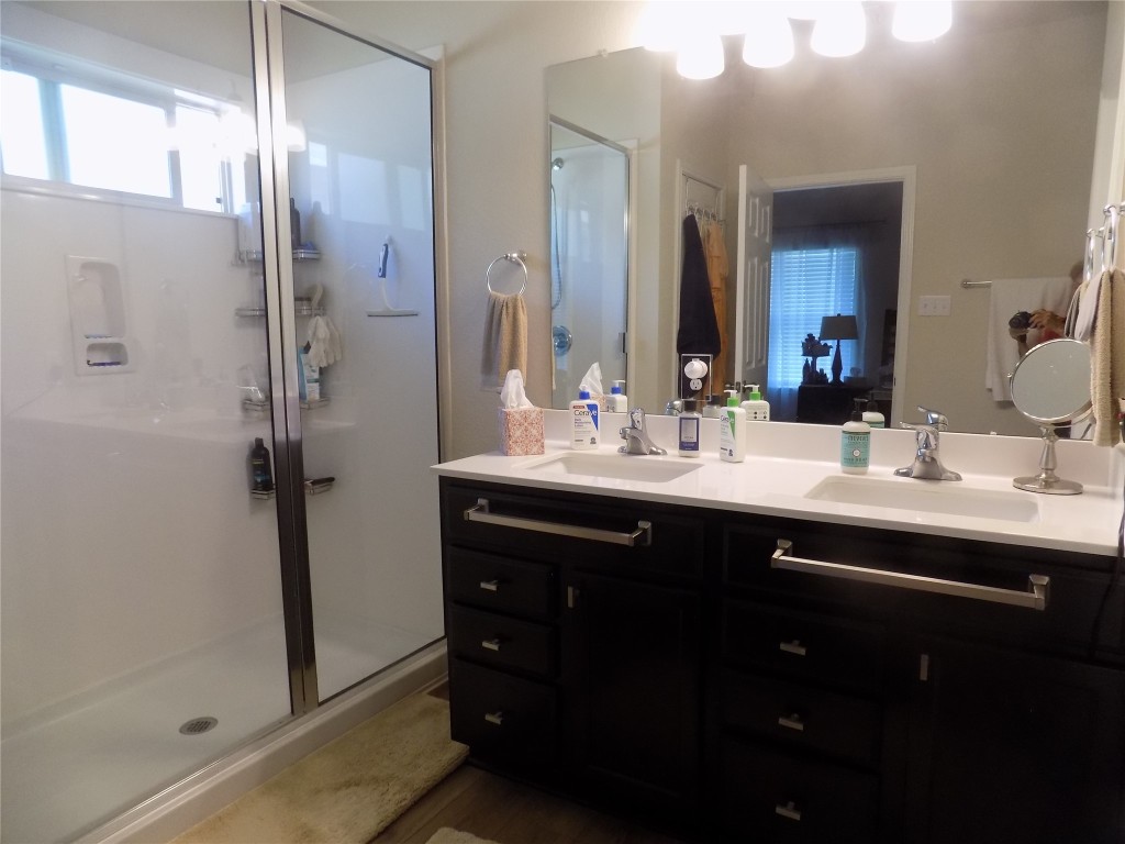 124 Rearden Boulevard Jarrell, TX 76537 - Photo 14 of 16 a bathroom with a double vanity sink and mirror