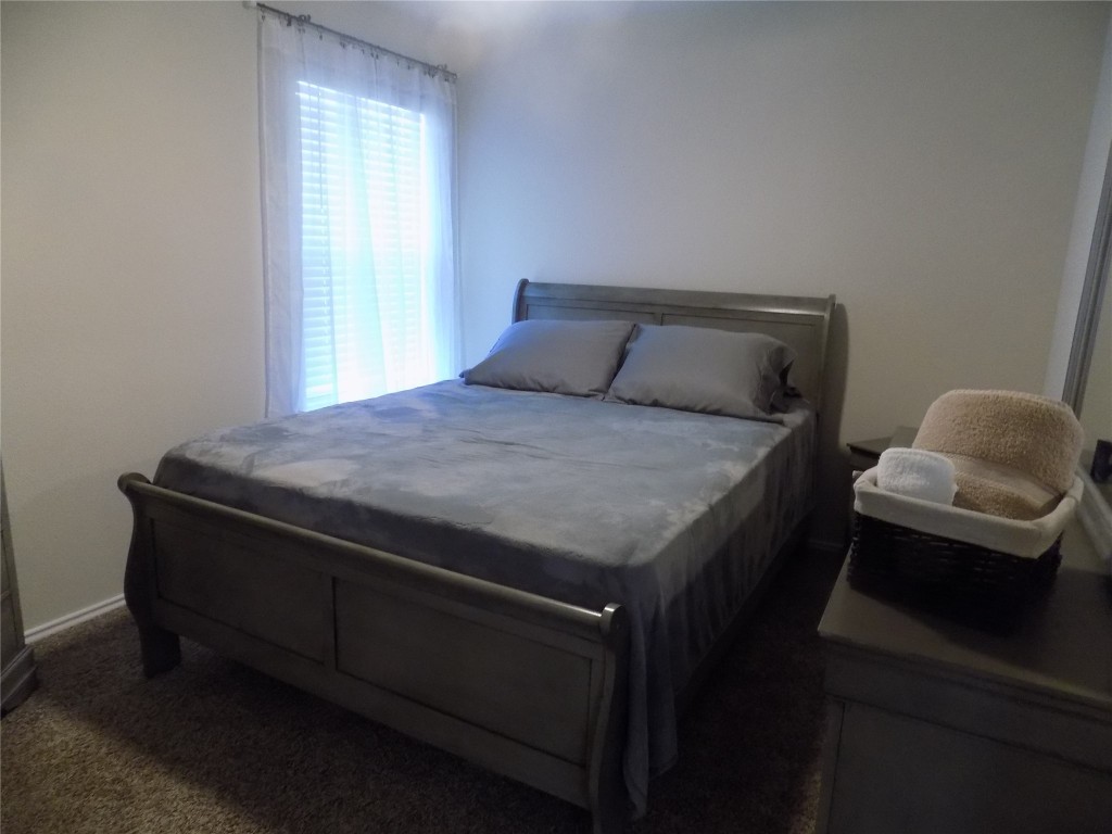 124 Rearden Boulevard Jarrell, TX 76537 - Photo 15 of 16 a bed sitting in a bedroom next to a window