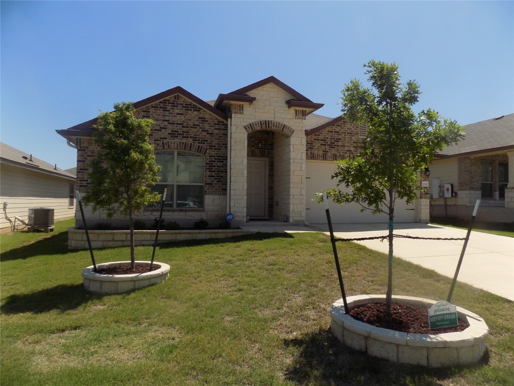 124 Rearden Boulevard Jarrell, TX 76537 - Photo 2 of 16 a view of a house with a swimming pool and a fountain