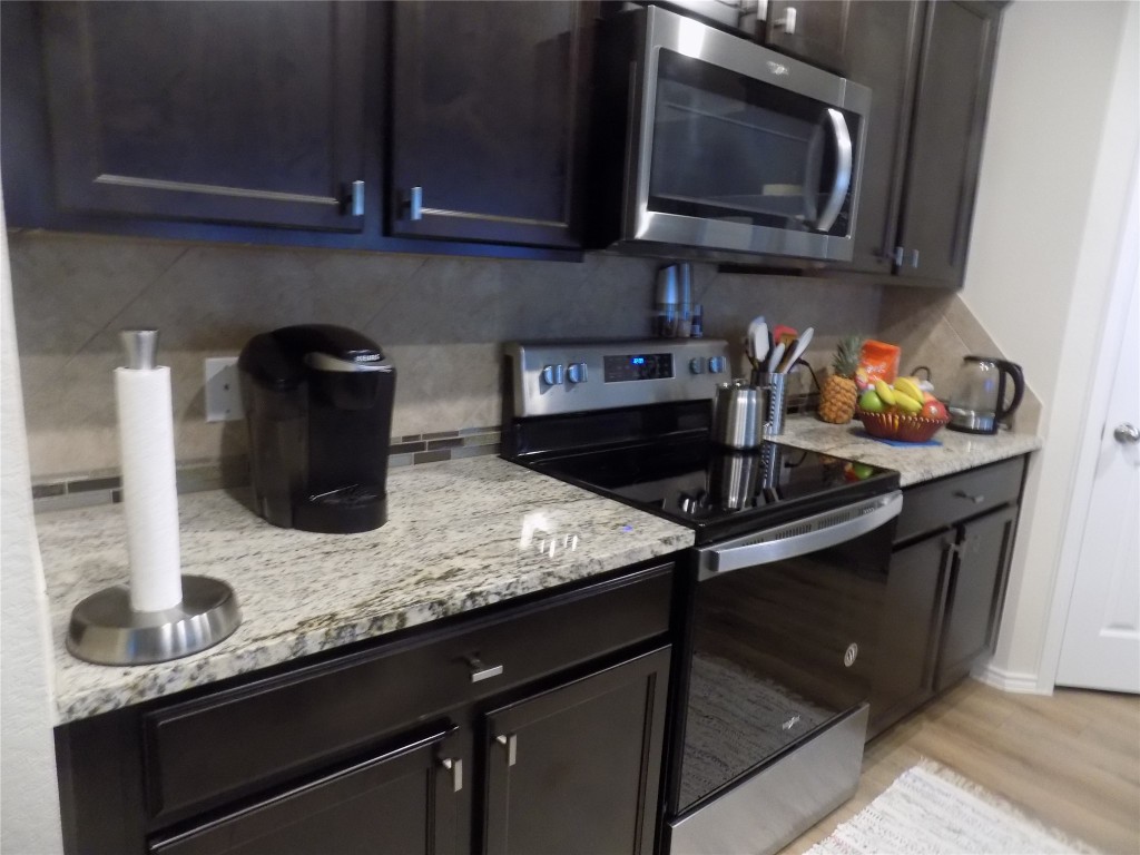 124 Rearden Boulevard Jarrell, TX 76537 - Photo 3 of 16 a kitchen with a sink and cabinets
