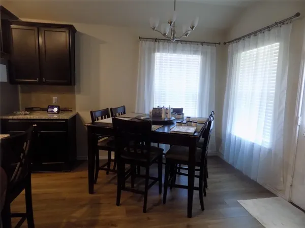 a view of a dining room with furniture and window