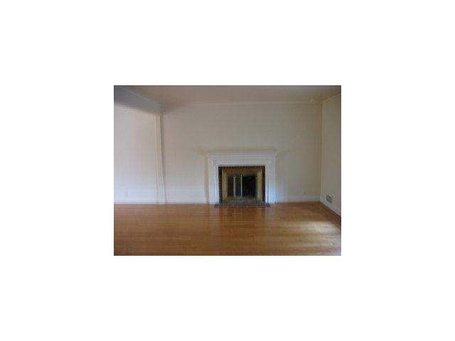 339 Paramount Drive Millbrae, CA 94030 - Photo 2 of 8 a open living room with a couch and a fireplace