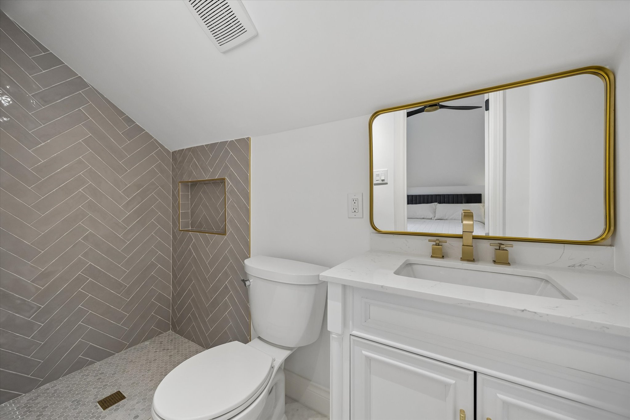 3719 Bee Creek Road Spicewood, TX 78669 - Photo 25 of 40 A well-appointed bathroom features a chic tiled shower with an integrated niche, complemented by a pristine vanity and modern fixtures.