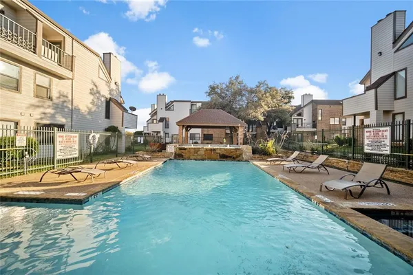 a view of a swimming pool with lounge chairs
