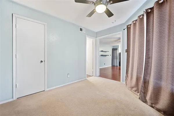 a view of a livingroom with a ceiling fan and window