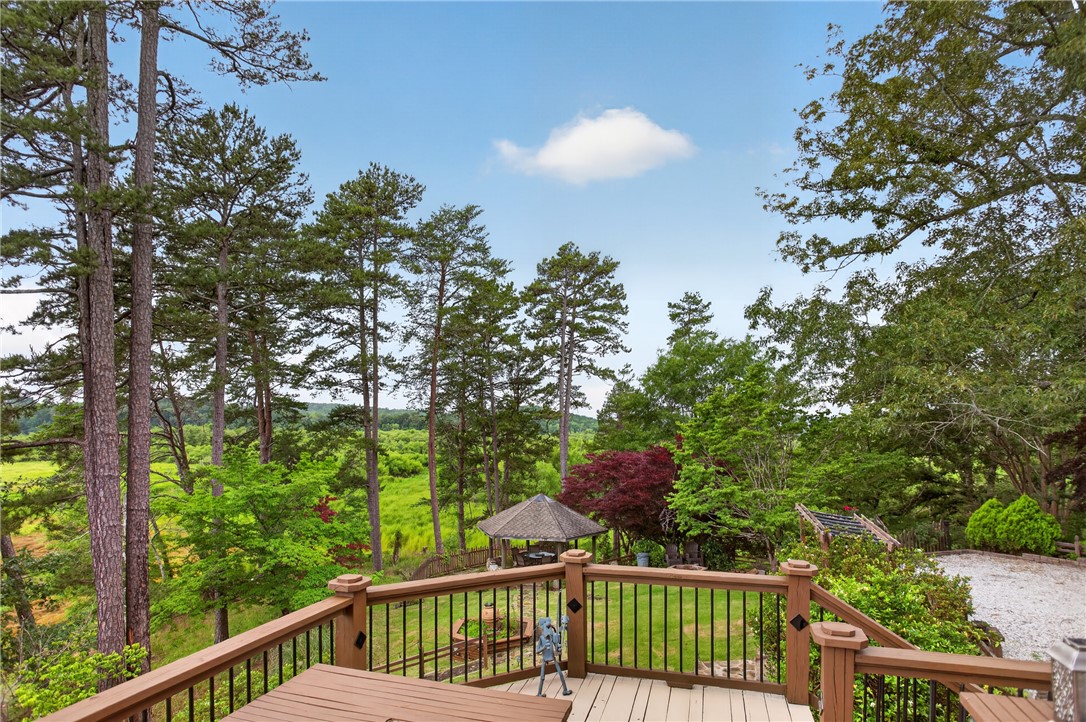 351 River Road Westminster, SC 29693 - Photo 46 of 50 A spacious outdoor deck extends to a natural landscape with mature trees and a charming gazebo.